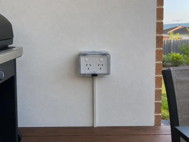 Outdoor double power point on a rendered wall above a timber deck in Caves Beach